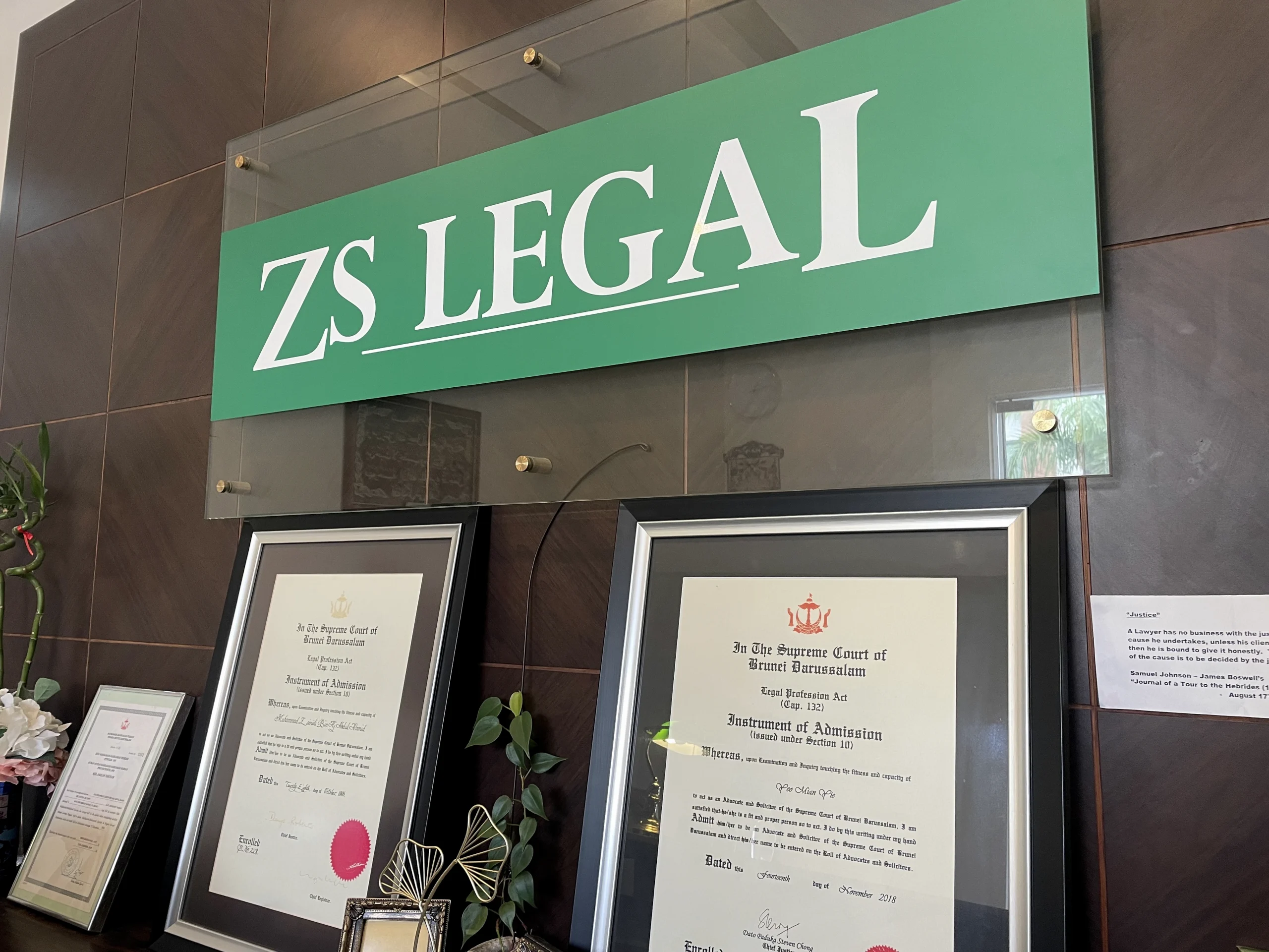 ZS Legal office sign displayed above framed certificates of admission in Brunei Darussalam